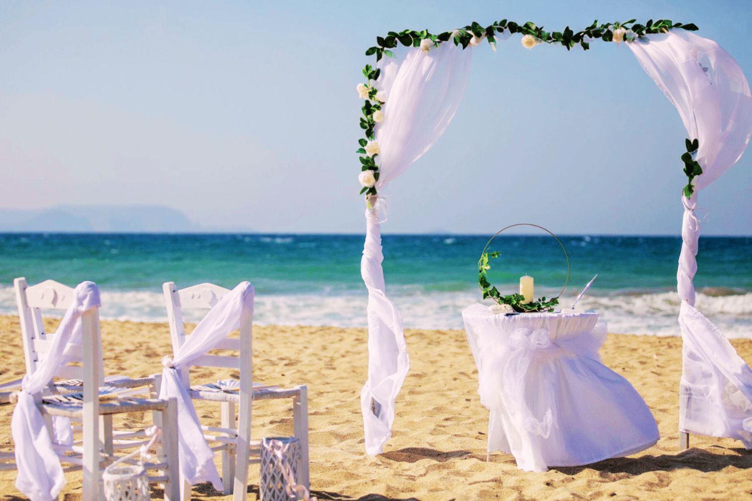 Arch & chairs set up for a beach ceremony in Analipsi Crete